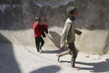 Children react after losing their mother in what activists said where explosive barrels thrown by forces loyal to Syrian President Bashar al-Assad in the Al-Andhirat neighbourhood of Aleppo