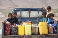 Children ride on the back of a truck loaded with water jerrycans at a camp for internally displaced people in the Dhanah area of the central province of Marib, Yemen, April 30, 2016. PHOTO BY REUTERS/Ali Owidha