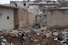 Children play near rubble of damaged buildings in al-Rai town, northern Aleppo countryside, Syria, December 25, 2016. PHOTO BY REUTERS/Khalil Ashawi