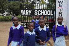 Kenyan children stand outside their primary school in a file photo. PHOTO BY REUTERS/Noor Khamis