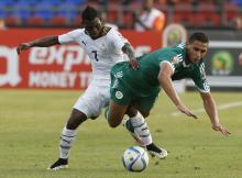 Ghana's Christian Atsu (L) challenges Algeria's Faouzi Ghoulam during their 2015 African Cup of Nations Group C soccer match in Mongomo, January 23, 2015. PHOTO BY REUTERS/Mike Hutchings