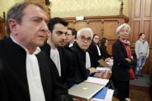 Managing Director of the International Monetary Fund (IMF) Christine Lagarde (R) stands with her lawyers before the start of her trial about a state payout in 2008 to a French businessman, at the courts in Paris, France, December 12, 2016. PHOTO BY REUTERS/Philippe Wojazer
