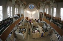 Beds for migrants, separated by impromptu partition screens, are set up inside a Protestant church in Oberhausen, Germany, October 30, 2015. PHOTO BY REUTERS/Ina Fassbender