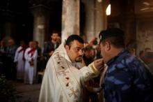 Iraqis attend the first Palm Sunday procession in the burnt out main church of the Christian city of Qaraqosh since Iraqi forces retook it from Islamic States militants, Iraq, April 9, 2017. PHOTO BY REUTERS/Suhaib Salem