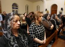 Iraqi Christians pray as they attend a Good Friday mass at a church in Baghdad, March 25, 2016. PHOTO BY REUTERS/Khalid al Mousily