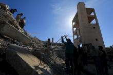 People and Civil Defense members remove rubble while looking for survivors in the ruins of a destroyed Medecins Sans Frontieres (MSF) supported hospital hit by missiles in Marat Numan, Idlib province, Syria, February 16, 2016. PHOTO BY REUTERS/Ammar Abdullah