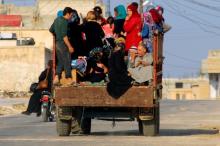 Civilians sit on a pick-up truck with their belongings in Taybat al Imam town after rebel fighters from the hardline jihadist Jund al-Aqsa advanced in the town in Hama province, Syria, August 31, 2016. PHOTO BY REUTERS/Ammar Abdullah
