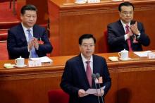 China's President Xi Jinping and China's Premier Li Keqiang clap as Chairman of the Standing Committee of the National People's Congress (NPC) Zhang Dejiang (front) speaks during the opening session of the National People's Congress (NPC) in Beijing, China, March 5, 2017. PHOTO BY REUTERS/Jason Lee