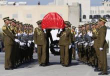Palestinian honor guards carry the coffin of Palestinian minister Ziad Abu Ein during his funeral in the West Bank city of Ramallah, December 11, 2014. PHOTO BY REUTERS/Ammar Awad