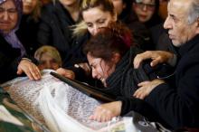 Asiye (L), mother of Destina Peri Parlak, one of the victims of Sunday's suicide bomb attack, mourns over her daughter's coffin during a funeral ceremony in Ankara, Turkey, March 15, 2016. PHOTO BY REUTERS/Umit Bektas