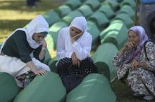 Women cry near coffins of their relatives, who are newly identified victims of the 1995 Srebrenica massacre, which are lined up for a joint burial in Potocari near Srebrenica, Bosnia and Herzegovina, July 11, 2017. PHOTO BY REUTERS/Dado Ruvic