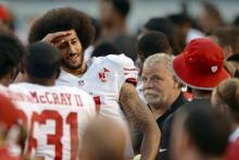 San Francisco 49ers quarterback Colin Kaepernick (left) sarcastically salutes a teammate before the national anthem before the game against the San Diego Chargers at Qualcomm Stadium, September 1, 2016. PHOTO BY REUTERS/Jake Roth-USA TODAY Sports