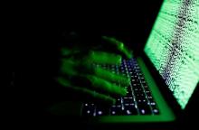 A man types on a computer keyboard in front of the displayed cyber code in this illustration picture taken March 1, 2017. PHOTO BY REUTERS/Kacper Pempel