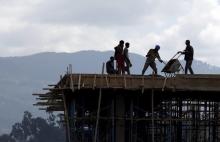 Construction workers work on the roof of a new building at the Mercato market in Addis Ababa, September 11, 2015. PHOTO BY REUTERS/Tiksa Negeri