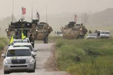 Kurdish fighters from the People's Protection Units (YPG) head a convoy of U.S military vehicles in the town of Darbasiya next to the Turkish border, Syria, April 28, 2017. PHOTO BY REUTERS/Rodi Said
