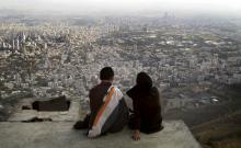 An Iranian couple sit overlooking the city of Tehran, October 19, 2006. PHOTO BY REUTERS/Morteza Nikoubazl
