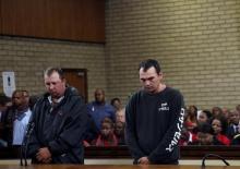 Theo Martins (L) and Willem Oostheizen appear in court after an online video emerged showing them pushing a black man into a coffin and threatening to burn him alive, at the Middleburg magistrates High Court, in Mpumalanga province, South Africa, November 16, 2016. PHOTO BY REUTERS/Siphiwe Sibeko