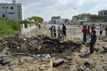 People gather around a crater caused by a Saudi-led air strike in Yemen's Red Sea port city of Houdieda, December 28, 2015. PHOTO BY REUTERS/Abduljabbar Zeyad