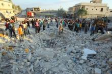 Residents inspect a site damaged by an airstrike in Hafsarja, in the insurgent stronghold of Idlib province, Syria, May 9, 2016. PHOTO BY REUTERS/Ammar Abdullah