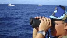 A crewman from the Vietnamese coastguard ship 8003 looks out at sea as Chinese coastguard vessels give chase to Vietnamese ships that came close to the Haiyang Shiyou 981, known in Vietnam as HD-981, oil rig in the South China Sea, July 15, 2014. PHOTO BY REUTERS/Martin Petty