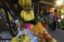 Customers pick fresh produce to buy from a vender in Khartoum, Sudan, December 1, 2016. PHOTO BY REUTERS/Mohamed Nureldin Abdallah