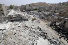 A general view shows the damage after a Syrian army fighter jet crashed into a busy marketplace in the rebel-held northwestern town of Ariha, August 3, 2015. PHOTO BY REUTERS/Ammar Abdullah