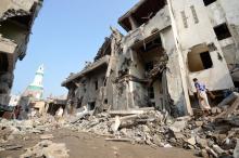 A man walks on the rubble of houses at the site of a Saudi-led air strike in the Red Sea port city of Hodeidah, Yemen, September 22, 2016. PHOTO BY REUTERS/Abduljabbar Zeyad
