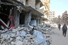 Men walk past damaged shops at a site hit yesterday by airstrikes in the rebel held al-Shaar neighbourhood of Aleppo, Syria, November 17, 2016. REUTERS/Abdalrhman Ismail