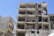 A damaged building is pictured at a site hit by what activists said were two barrel bombs dropped by forces loyal to Syria's President Bashar al-Assad in al-Katerji district in Aleppo