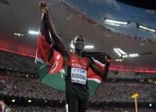 David Rudisha (KEN) takes a victory lap with Kenyan flag after winning the 800m in 1:45.84 during the IAAF World Championships in Athletics at National Stadium. PHOTO BY Kirby Lee-USA TODAY Sports