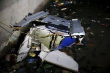 Debris of an helicopter is washed ashore Lagos Lagoon after it crashed into the lagoon in Oworonsoki district in Lagos, August 12, 2015. PHOTO BY REUTERS/Akintunde Akinleye