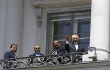 Iranian Foreign Minister Javad Zarif (R) listens to questions from journalists as he stands next to Iran's chief nuclear negotiator Abbas Araghchi (L) and Hossein Fereydoon (2nd L), brother and close aide to President Hassan Rouhani, on the balcony of Palais Coburg, the venue for nuclear talks in Vienna, Austria, July 10, 2015. PHOTO BY REUTERS/Leonhard Foeger
