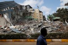 A man walks by as heavy machinery demolishes the UKAY Mall in Westlands, Nairobi, Kenya, August 14, 2018. PHOTO BY REUTERS/Baz Ratner