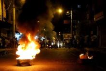 Demonstrators burn tyres to block a street during protests against Monday's bomb attack in Suruc, in the Kurdish dominated southeastern city of Diyarbakir, Turkey, July 21, 2015. PHOTO BY REUTERS/Sertac Kayar