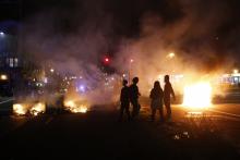 Demonstrators gather around a street fire during a demonstration following the grand jury decision on Monday in the Ferguson, Missouri shooting of Michael Brown, in Oakland, California November 25, 2014. PHOTO BY REUTERS/Stephen Lam