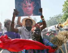 A demonstrator carries a portrait depicting Prime Minister Laurent Lamothe as a demon during an anti-government protest in Port-au-Prince, December 6, 2014. PHOTO BY REUTERS/Marie Arago