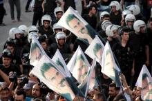 Demonstrators hold flags with pictures of imprisoned Kurdish rebel leader Abdullah Ocalan, during a protest against latest security operations in Diyarbakir, Turkey, September 6, 2015. PHOTO BY REUTERS/Sertac Kayar