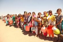 Displaced people from the minority Yazidi sect, fleeing violence in the Iraqi town of Sinjar west of Mosul, line up to receive food at the khanki camp on the outskirts of Dohuk province, September 13, 2014. PHOTO BY REUTERS/Ari Jalal