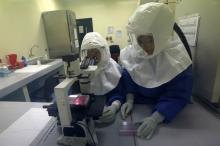 Doctors work in a Biosafety Level III laboratory at the National Institute of Health in Lima