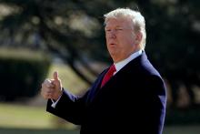 U.S. President Donald Trump gestures as he walks on South Lawn of the White House in Washington, U.S., before his departure to the Customs and Border Protection National Targeting Center, February 2, 2018. PHOTO BY REUTERS/Yuri Gripas