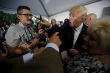 U.S. Republican presidential candidate Donald Trump points into the crowd after speaking to reporters at a campaign fundraiser at the home of car dealer Ernie Boch Jr. in Norwood, Massachusetts, August 28, 2015. PHOTO BY REUTERS/Brian Snyder