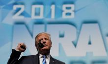 President Donald Trump makes a fist as he addresses the National Rifle Association (NRA) Convention in Dallas, Texas, May 4, 2018. PHOTO BY REUTERS/Carlos Barria