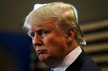 Republican U.S. presidential candidate Donald Trump talks to the media in the "spin room" after the Republican U.S. presidential candidates debate sponsored by ABC News at Saint Anselm College in Manchester, New Hampshire, February 6, 2016. PHOTO BY REUTERS/Carlo Allegri