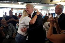 Republican presidential nominee Donald Trump is hugged by supporter Tracy McCullough during a campaign stop at the Boulevard Diner in Dundalk, Maryland, September 12, 2016. PHOTO BY REUTERS/Mike Segar