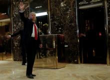 U.S. President-elect Donald Trump waves to supporters as he makes an appearance in the lobby at Trump Tower in New York, U.S., January 13, 2017. PHOTO BY REUTERS/Mike Segar