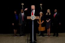 U.S. President Donald Trump is flanked by Ben Carson (2nd L), Carson's wife, Candy Carson (L), Martin Luther King Jr's niece Alveda KIng (3rd R), Trump's daughter Ivanka Trump (2nd R), and U.S. Senator Tim Scott (R-SC) (R) as he delivers remarks in Washington, U.S., February 21, 2017. PHOTO BY REUTERS/Jonathan Ernst
