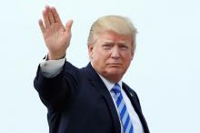 U.S. President Donald Trump waves as he boards Air Force One at Joint Base Andrews outside Washington, U.S., before traveling to Palm Beach, Florida for the Good Friday holiday/Easter weekend, April 13, 2017. PHOTO BY REUTERS/Yuri Gripas