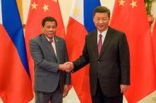 Chinese President Xi Jinping shakes hands with Philippines President Rodrigo Duterte in Beijing. PHOTO BY REUTERS/Etienne Oliveau