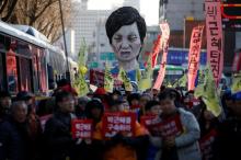 An effigy of South Korean President Park Geun-hye is seen behind people marching towards the Presidential Blue House during a protest calling for South Korean President Park Geun-hye to step down in central Seoul, South Korea, December 10, 2016. The signs read, "Arrest Park Geun-hye". PHOTO BY REUTERS/Kim Hong-Ji