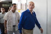 Former Israeli Prime Minister Ehud Olmert (R) leaves Tel Aviv District Court
